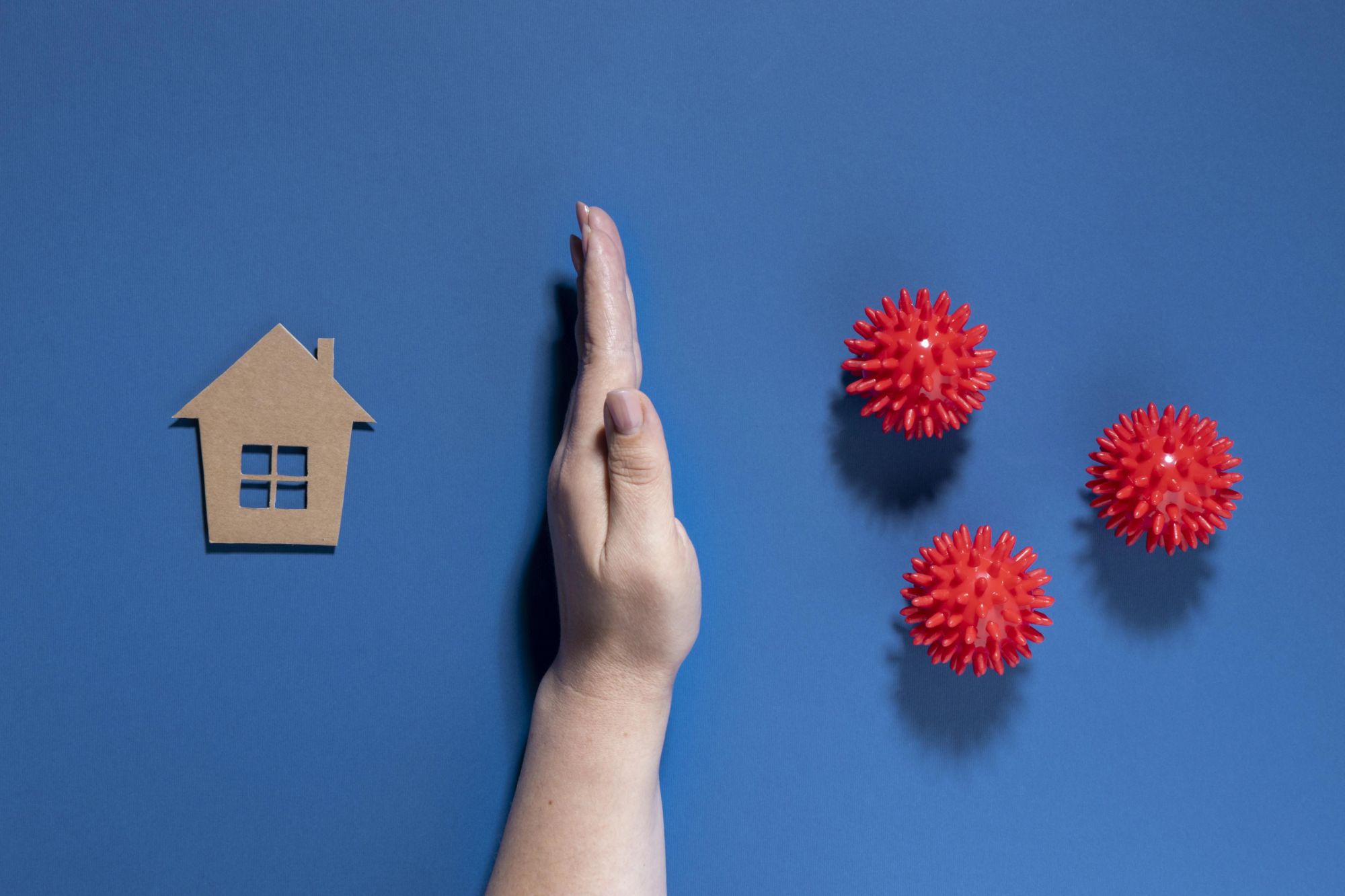 flat-lay-hand-protecting-house-from-viruses